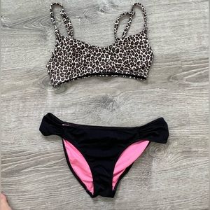 Leopard print bikini top and black bottoms